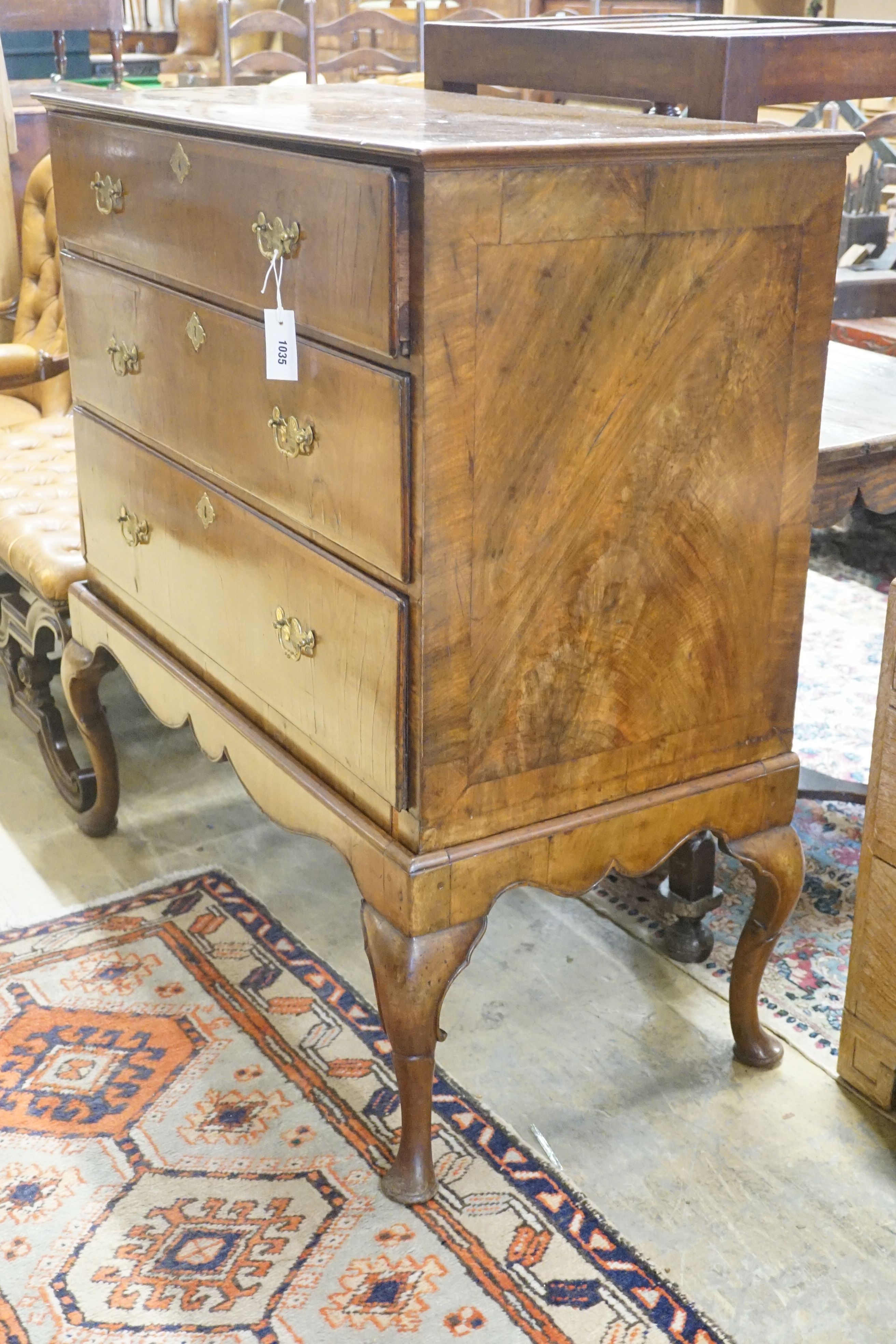 An 18th century walnut chest on later stand, width 104cm depth 52cm height 110cm